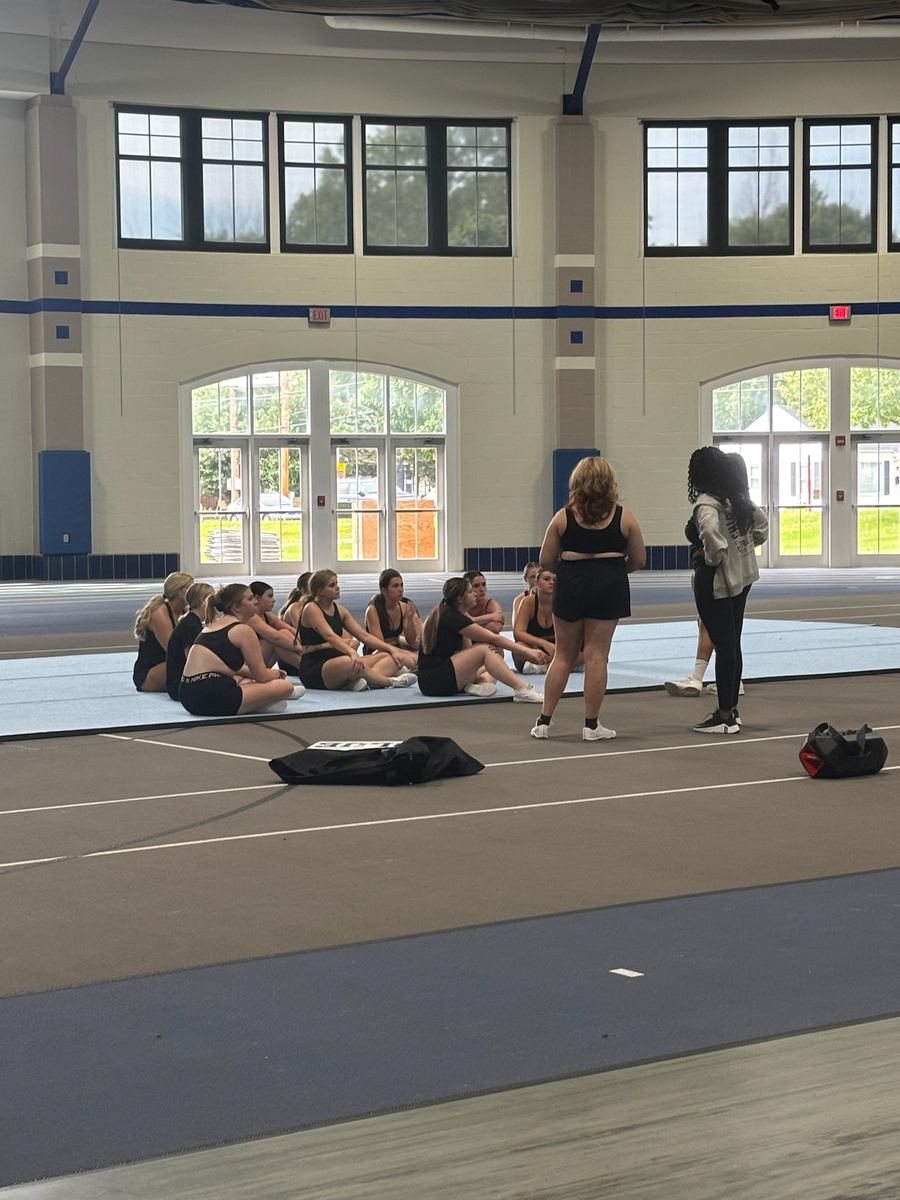 Cheer athletes sitting together at the end of the clinic