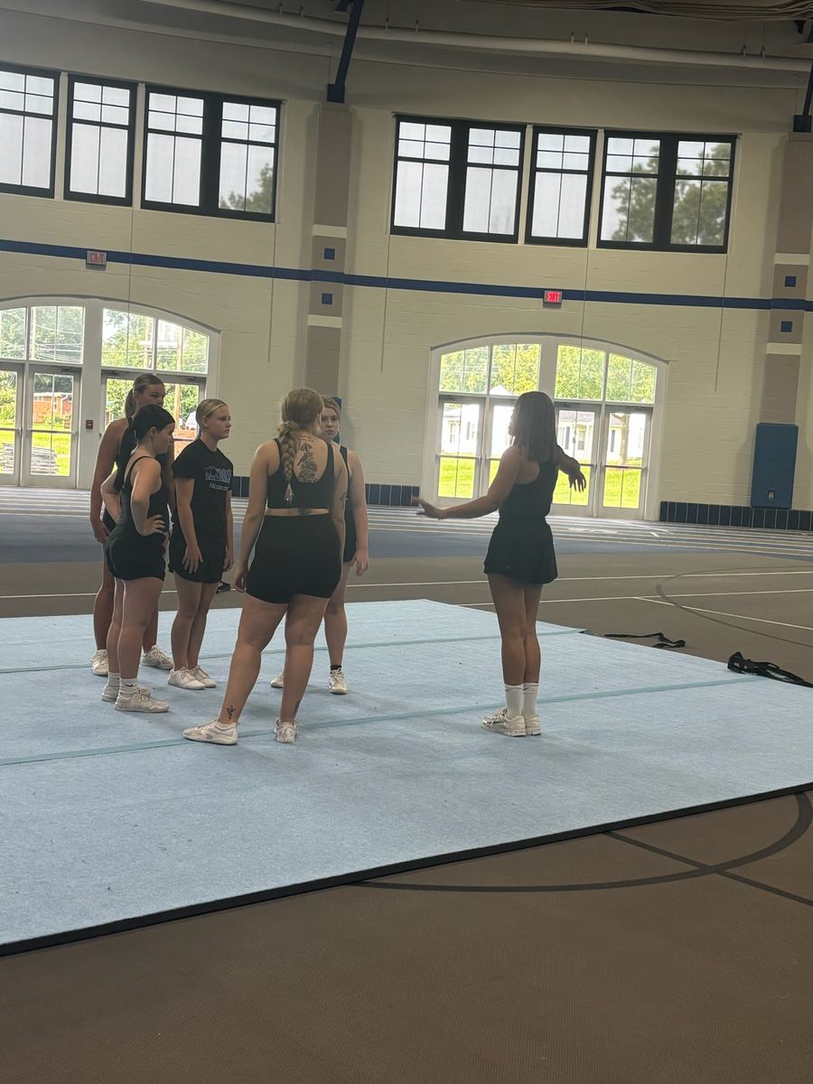 Cheer athletes warming up at the start of the clinic